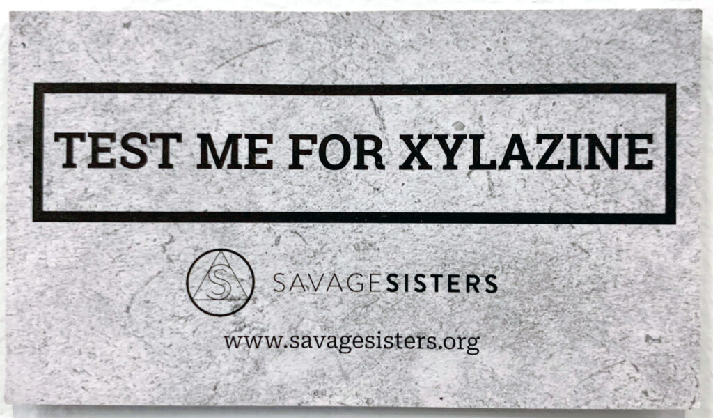 Savage Sisters distribute informational cards about xylazine to people who use drugs.