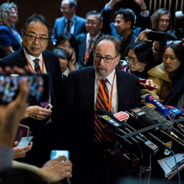 This picture taken on November 27, 2018 shows biologist and summit chair David Baltimore (centre R) of the California Institute of Technology speaking at a press conference during the Second International Summit on Human Genome Editing in Hong Kong.