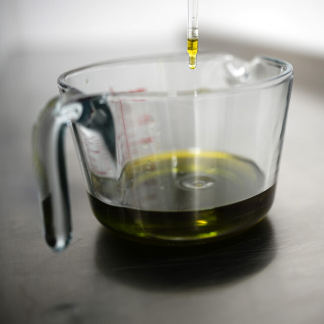 a drop of hemp oil drips into a beaker – first opinion coverage from STAT