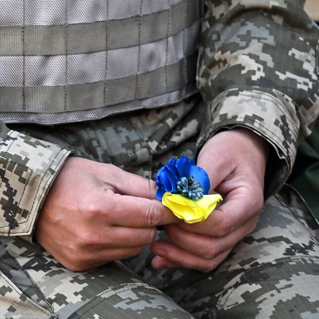 A Ukrainian cadet holds an artificial flower in the colors of the Ukrainian flag. -- first opinion coverage from STAT