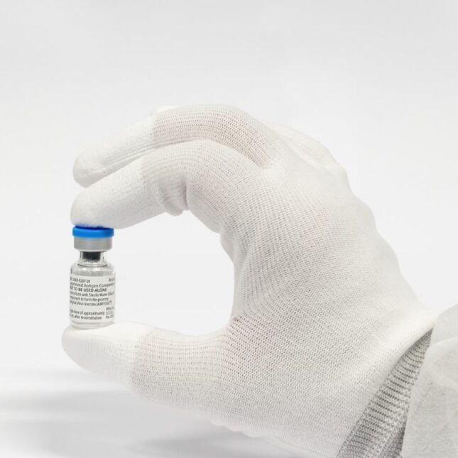 RSV vial in the hand of someone wearing a glove. -- infectious disease coverage from STAT