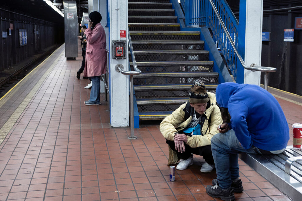 Anderson speaks with a friend who is without housing while taking the subway in Philadelphia. Anderson had just purchased breakfast for himself but quickly gave the food to his friend.